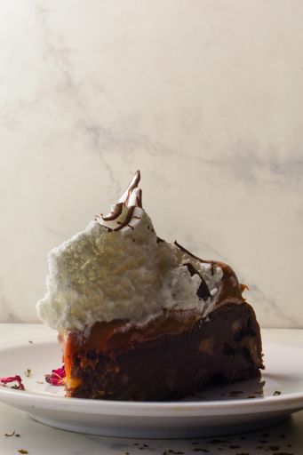 A vertical shot of brownie slice on a plate