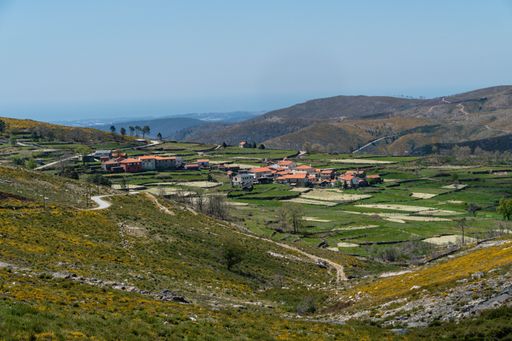 A beautiful green mountainous landscape with a village