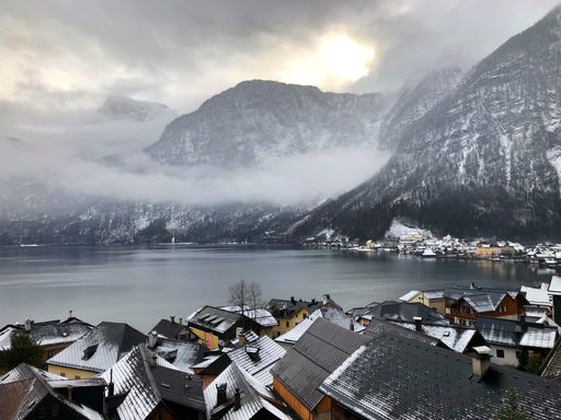 A scenic view of the lake by snow-capped mountains in Hallstatt, Austria