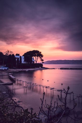 A vertical shot of the purple sunset at the coast of the French Riviera in France