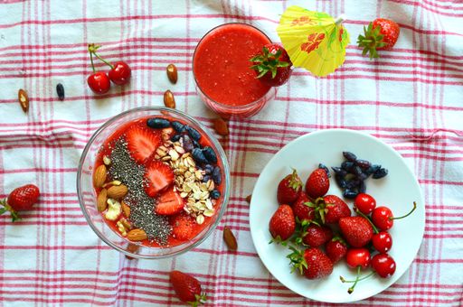A top view of a delicious smoothie bowl with fresh strawberries