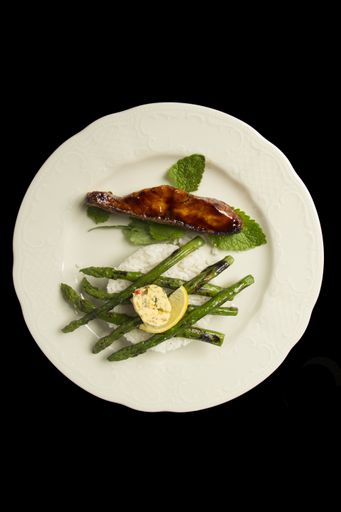 A salmon steak with fried asparagus and boiled rice