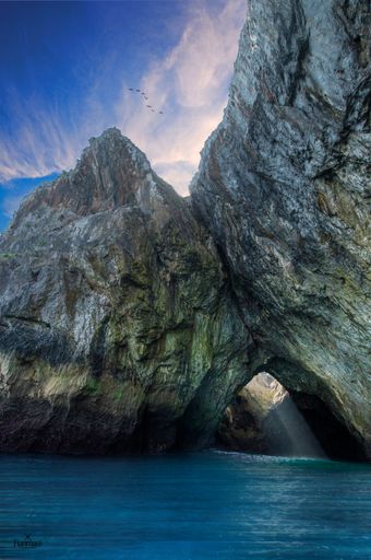 A vertical shot of a beautiful sea near the mountains in Asturias, Spain