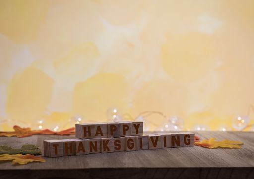 A closeup of Thanksgiving-related decorations with a yellow background