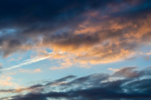 A beautiful sunset sky with orange puffy clouds