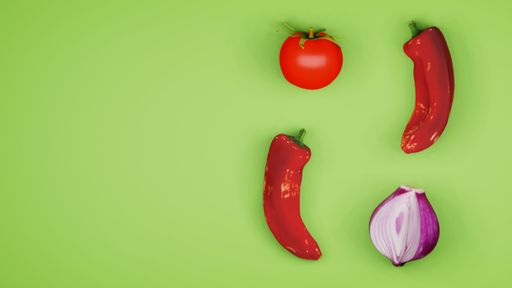 A top view of fresh red chili peppers, tomato, and onion on a green surface