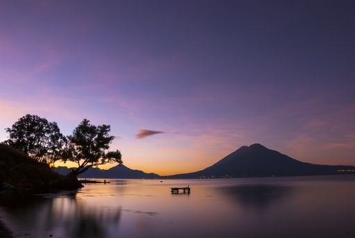 Sunrise in front of Lake Atitlan in Guatemala and volcano in background. Central America.