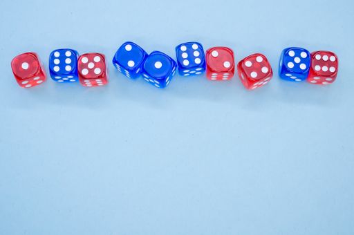 A top view of red and blue dice isolated on light blue background