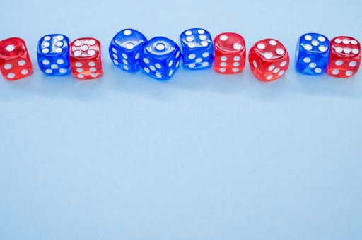 A top view of red and blue dice isolated on light blue background