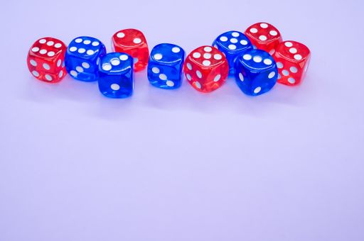 A top view of red and blue dice isolated on light violet background