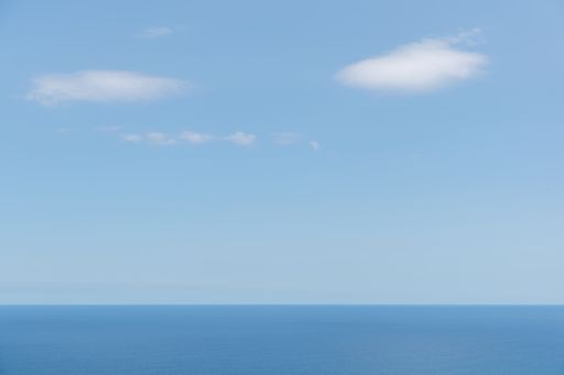Long aerial view of evening clouds over Tasman sea coast at Piha beach
