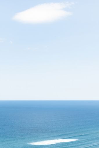 Long aerial view of evening clouds over Tasman sea coast at Piha beach