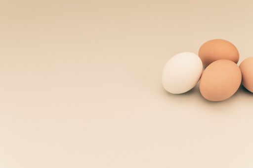 A high angle shot of organic fresh eggs isolated on light brown background