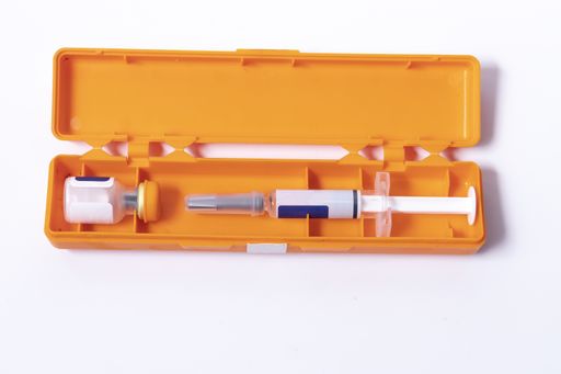 A high angle shot of a syringe kit with vaccine - concept of cure