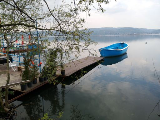 A park boat in the lake with an empty cafe
