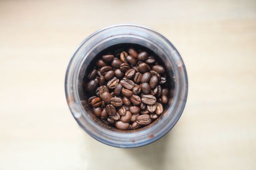 A top view of a cup with coffee beans