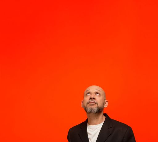 Portrait of an elegant business man looking up. Isolated on orange background.