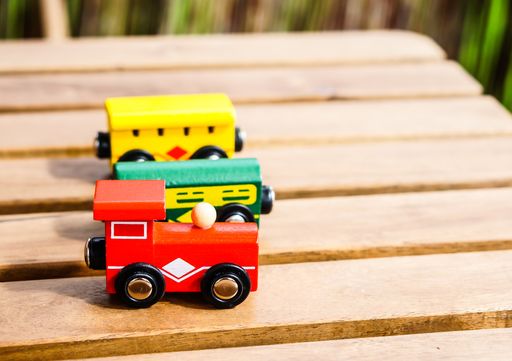 Colorful train wagon toys on a wooden table