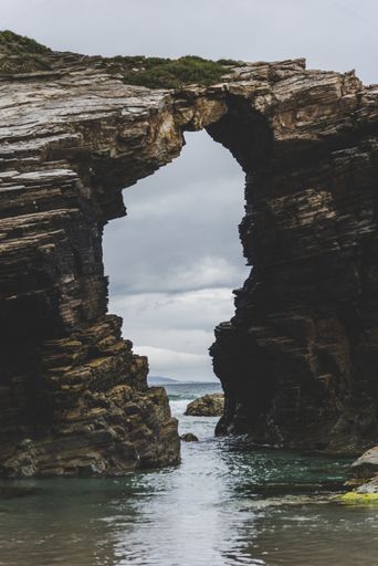 The Beach of the Cathedrals under a cloudy sky during daytime in Spain