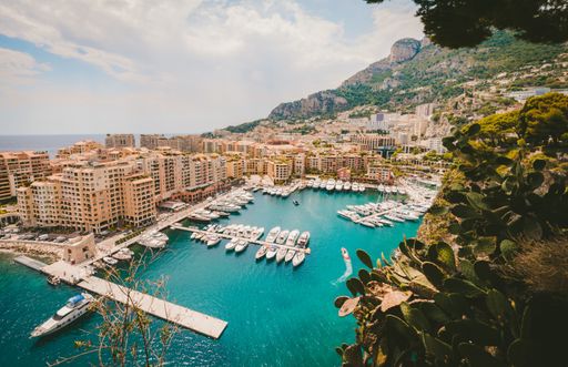 A high angle shot of the famous Port de Fontvieille in Monaco under the bright cloudy sky