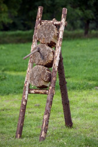 A closeup of a wooden stand with a thrown ax