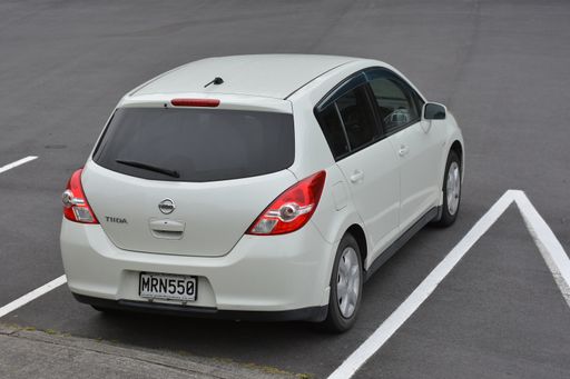 Aerial view of white Nissan Tiida at car park