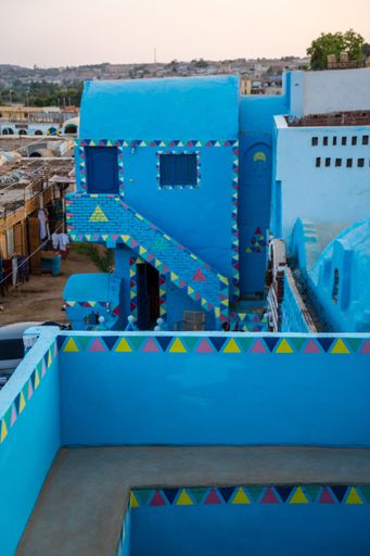 A vertical shot of a traditional blue house in a Nubian village along the Nile river and close to Aswan city, in Egypt