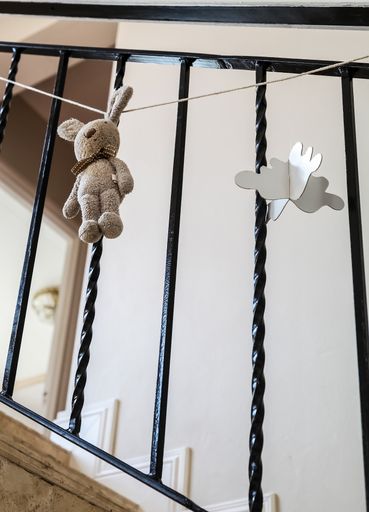 A vertical shot of stuffed toy fluffy animal hanging on a string at a child's birthday party
