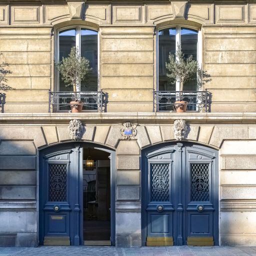 Paris, two ancient wooden doors, beautiful facade in a luxury neighborhood, rue Saint-Dominique, in the 7e arrondissement