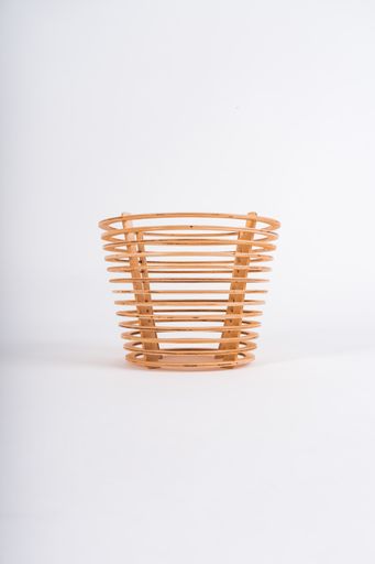 A vertical shot of a wooden basket on a white background