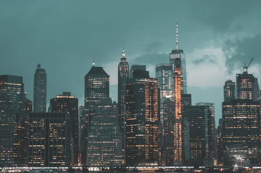 An urban scenery with modern buildings spreading light in the city under the gloomy sky