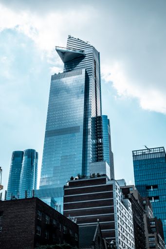 A vertical low angle shot of modern glass business buildings touching the sky