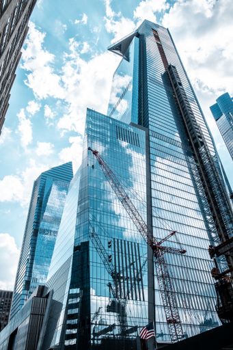 A vertical low angle shot of modern glass business buildings touching the sky
