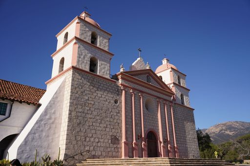 A low angle shot of the chapel at Mission Santa Barbara against the background of a blue sky