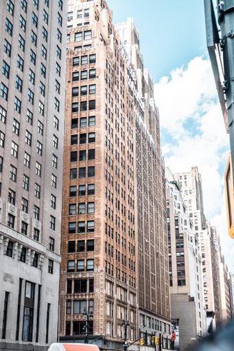 A vertical low angle shot of buildings touching the sky in the middle of the city