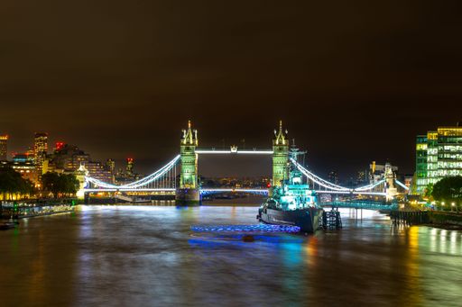 A nigh scene of the Tower Bridge in London over motion lights, United Kingdom