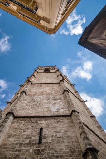 A low angle shot of a cathedral under a cloudy sky in Valencia, Spain