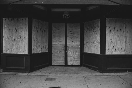 A grayscale shot of a building entrance