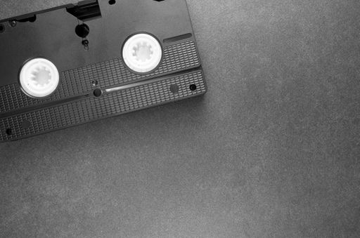A high angle shot of a videotape on a black surface