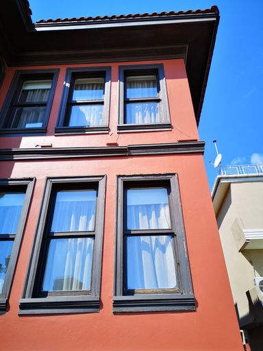 A vertical low angle shot of a building captured during the daytime
