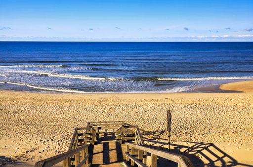 A high angle shot of a wooden staircase leading to the beach in Kampen, Sylt, Germany