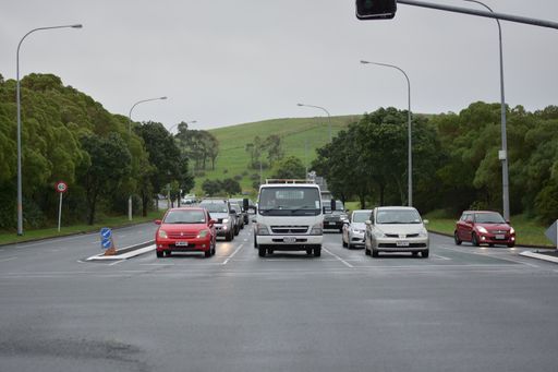 Front view of cars stopped at traffic light at Smales Road from Re Irirangi Drive
