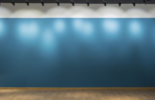 Background, empty turquoise interior wall of a house lit by spotlights from above