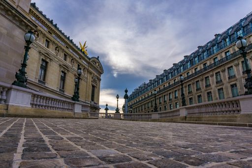 The beautiful historical buildings in Paris under the dark cloudy sky