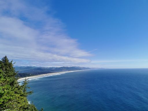 A high angle shot of the sea near the shore under the cloudy sky