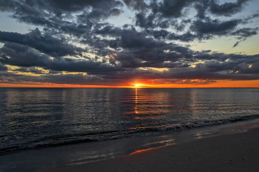 A breathtaking sunset view in the cloudy sky over the ocean