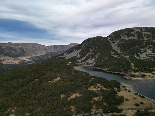 An aerial view of a beautiful mountainous landscape with a lake in Rila National Park, Bulgaria.