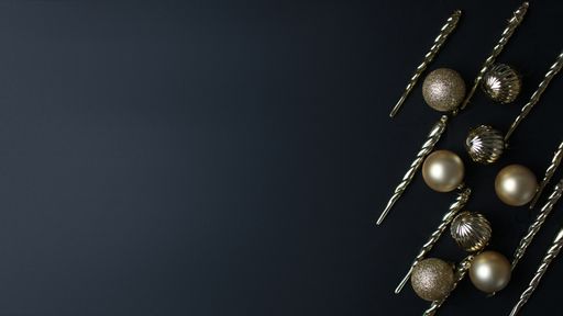 A top view of Christmas tree ornaments on a dark background with a copy space