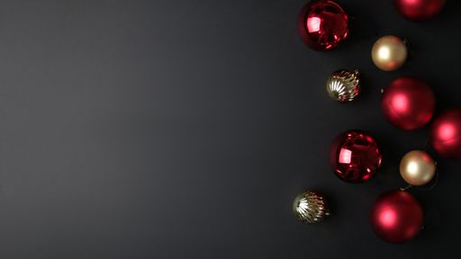 A top view of Christmas tree ornaments on a dark background with a copy space