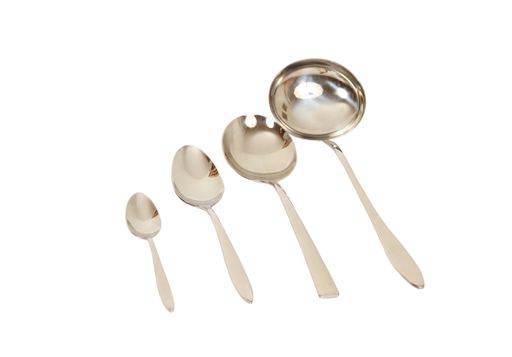 A high angle shot of four different spoons on a white background